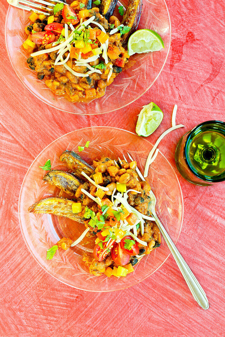 Vegetarian three-bean chilli fries on a pink background