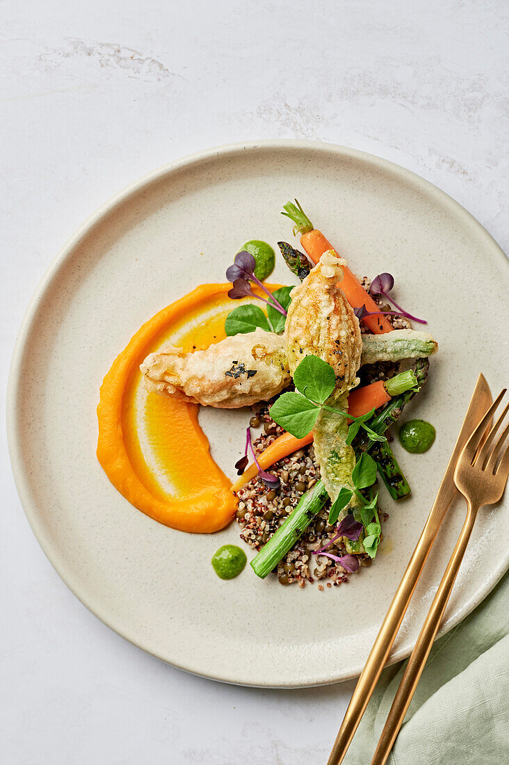 Stuffed courgette flowers, carrot puree, salsa verde, charred asparagus, quinoa and lentils