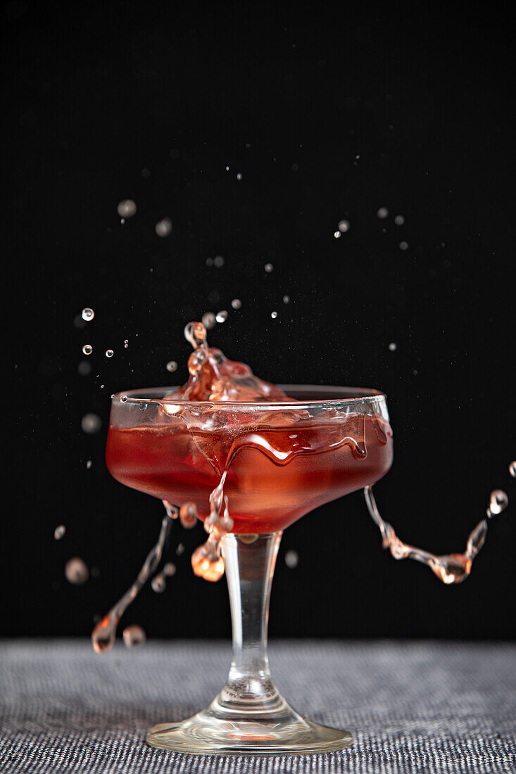 A splash in a cocktail glass with empty space