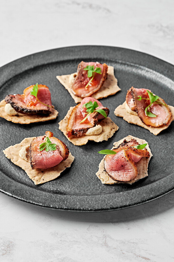 Duck breast, fennel seeds & black pepper crackers, macadamia mousse, orange glaze & chilli salt