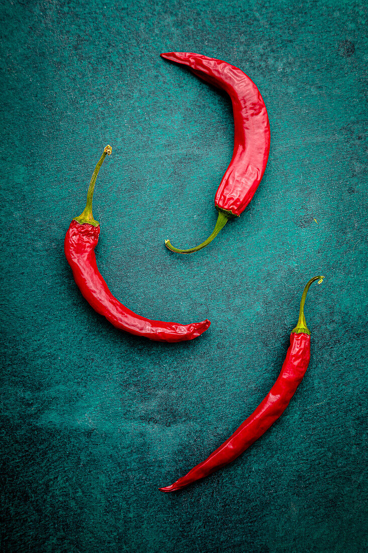 Chilli peppers over green background