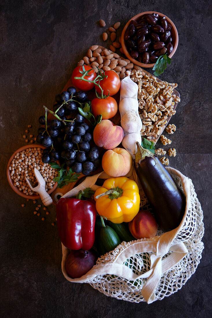 Mediterranean diet raw ingredients including fruit, vegetables legumes and nuts.
