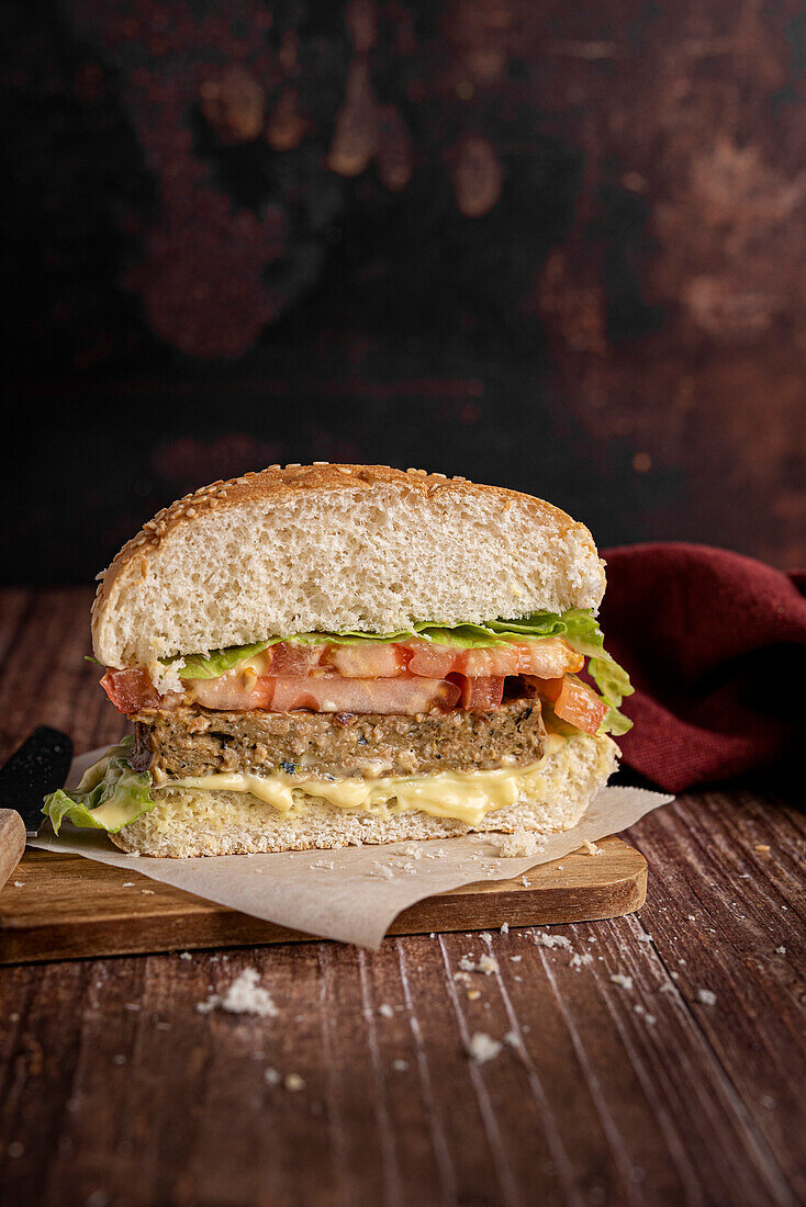 Vegan burger with vegetable patty on a wooden base