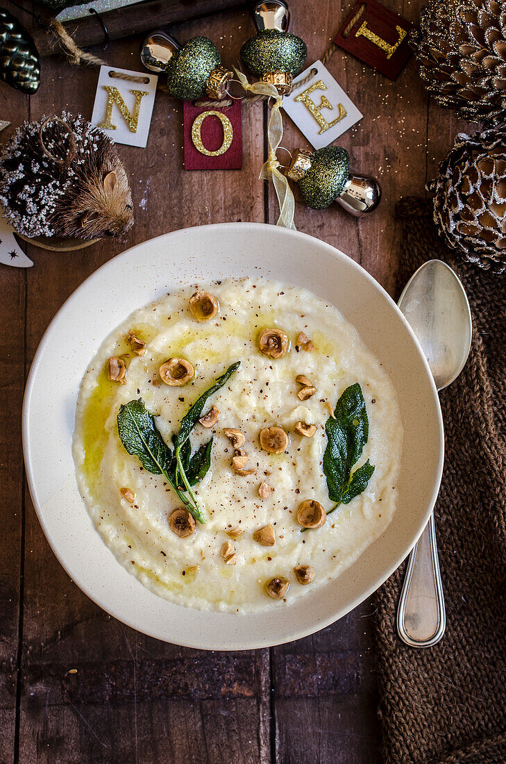 Celery root soup with sage and hazelnuts with Noel sign for Christmas