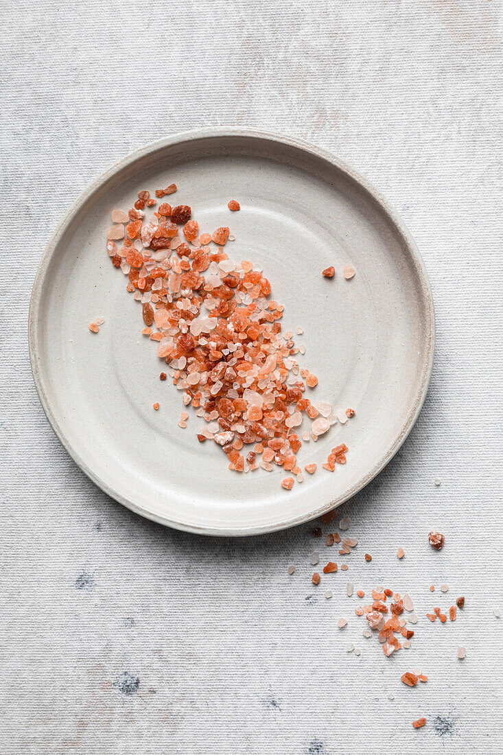 Pink Himalayan salt rocks on plate