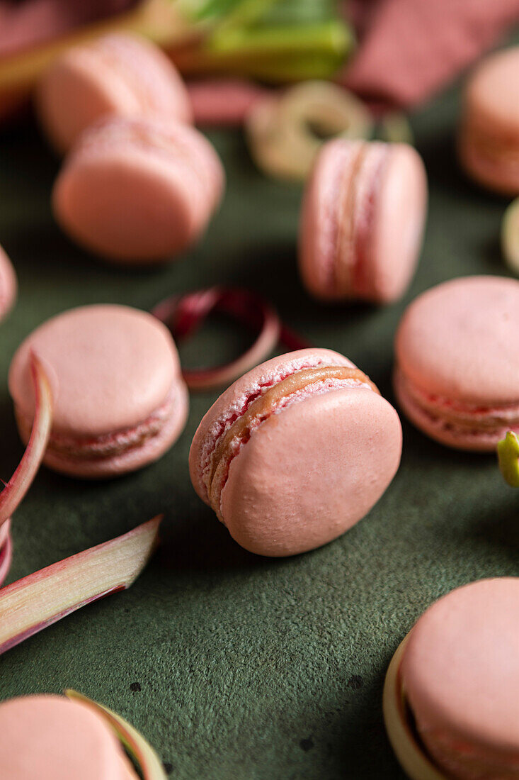 Rhubarb macarons on a green background