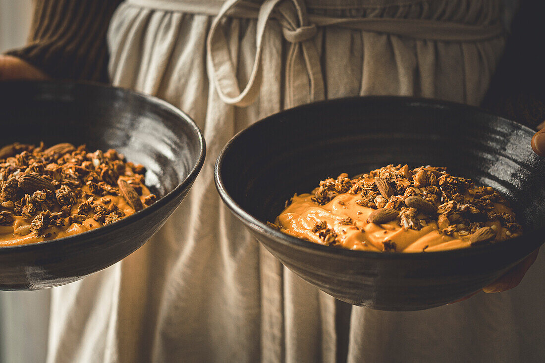 Eine Frau hält eine Smoothie Bowl