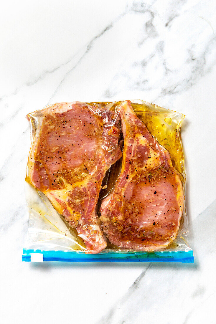 Pork chop marinating in olive oil,garlic and spices
