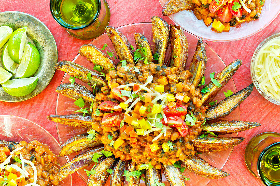 Vegetarian three-bean chilli fries on a pink background