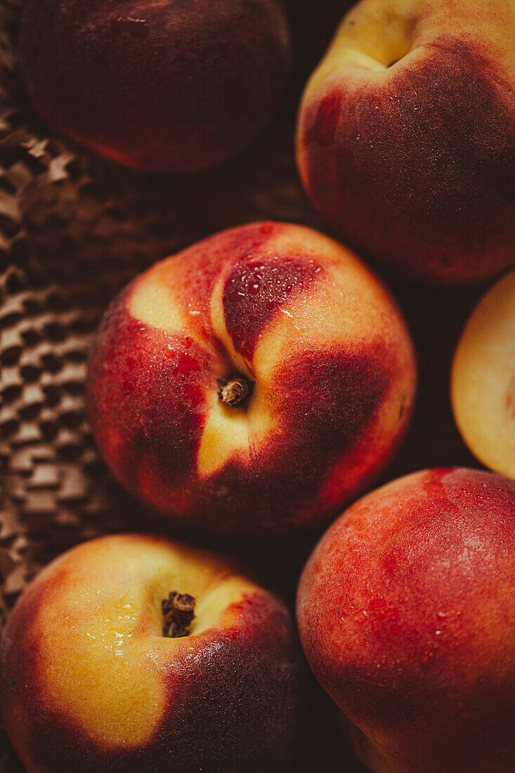 Ripe peaches are prepared on a kitchen table