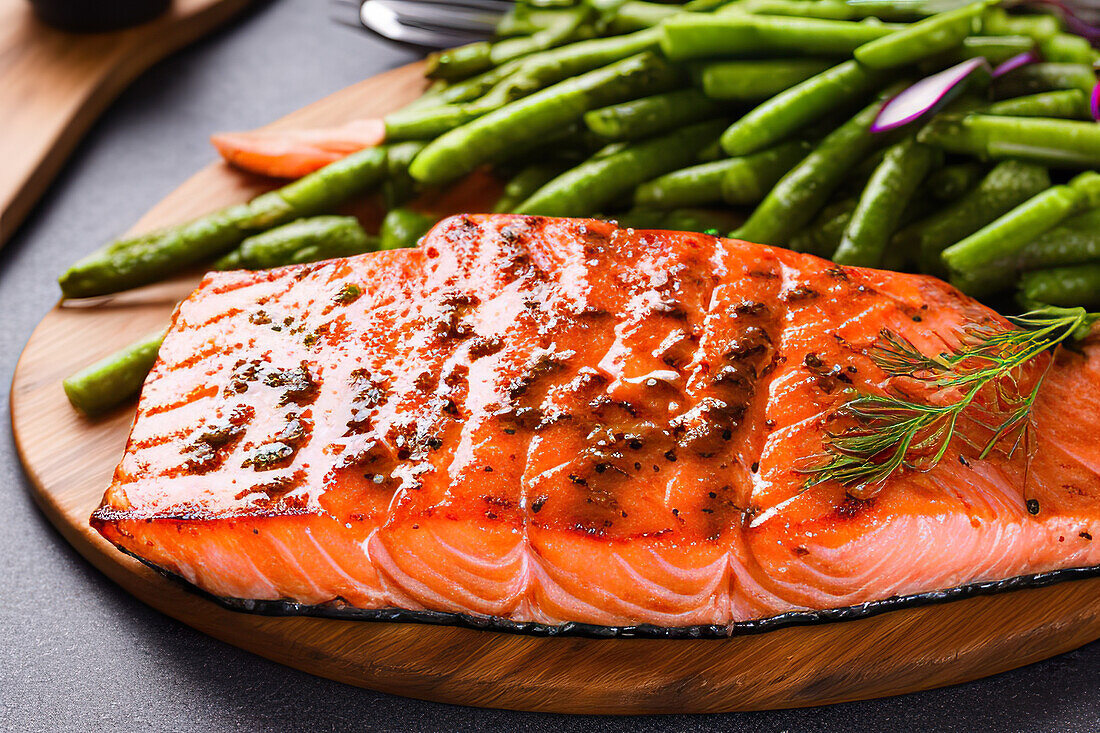 Generative AI illustration of delicious homemade baked salmon served on wooden board with green beans