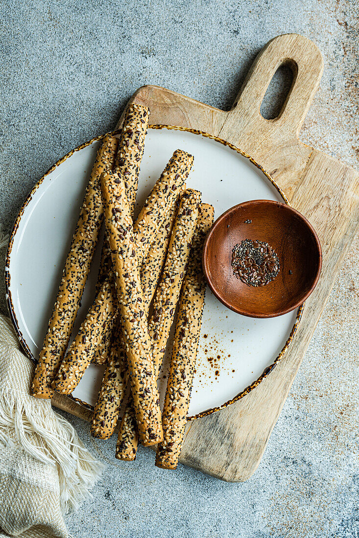 Freshly baked breadsticks with seed mix on the plate