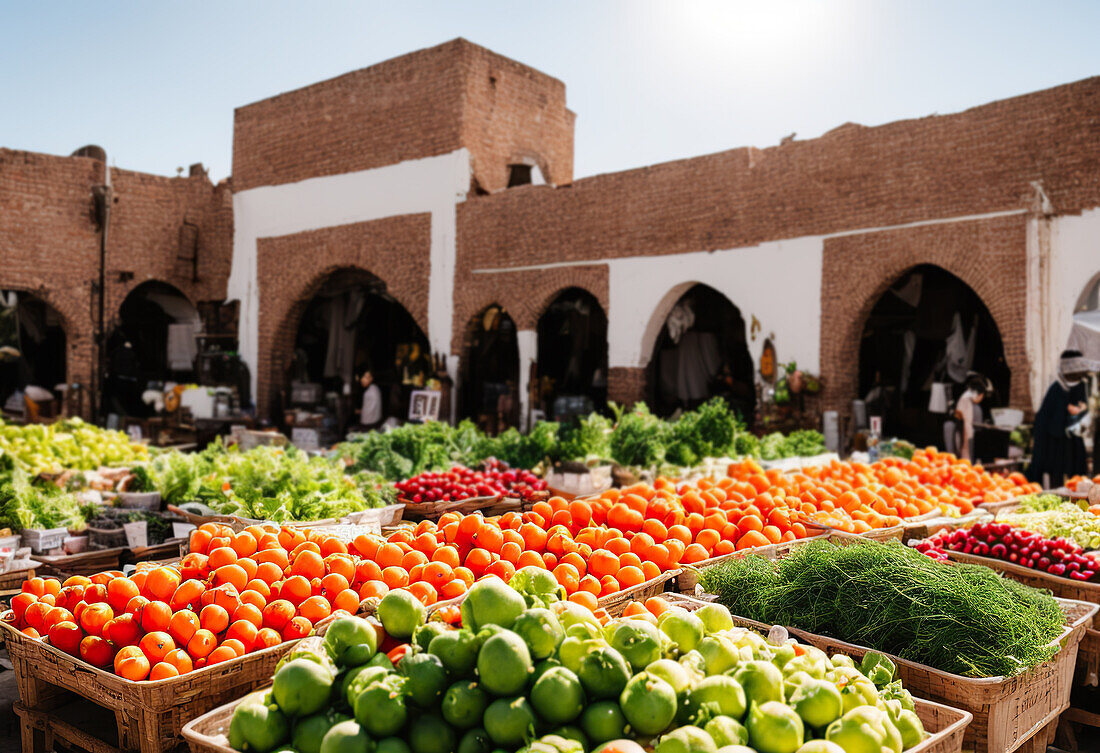 Wide angle view of bazaar with heap of fresh ripe fruits and vegetables with tomatoes and spinach placed on stall in local market
