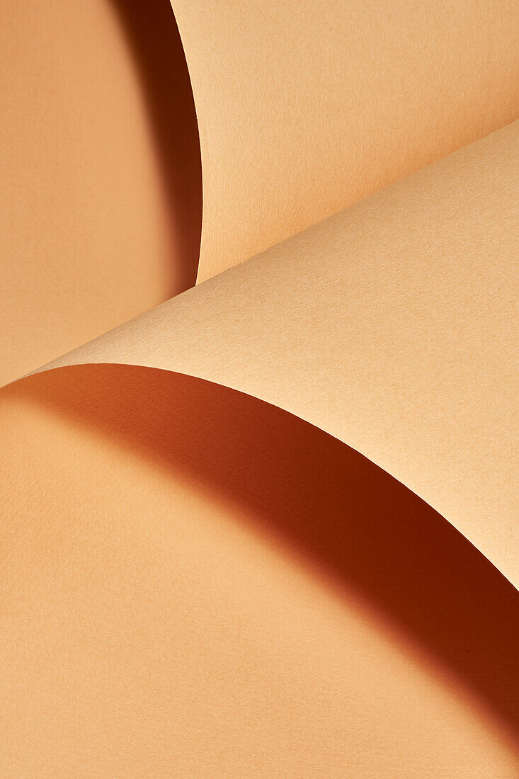 Closeup of naturally rolled craft paper background with a beautiful studio light