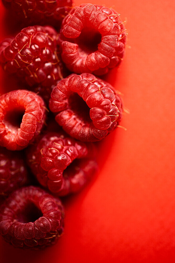 From above fresh sweet red raspberries arranged together representing concept of healthy diet