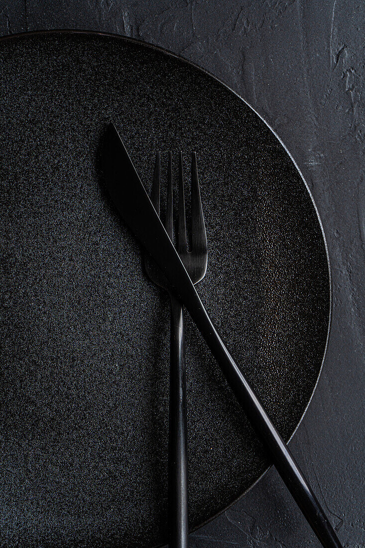 Minimalistic table setting with tableware and cutlery on concrete background