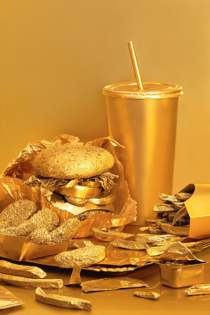 Golden street food spread on a table against a golden background