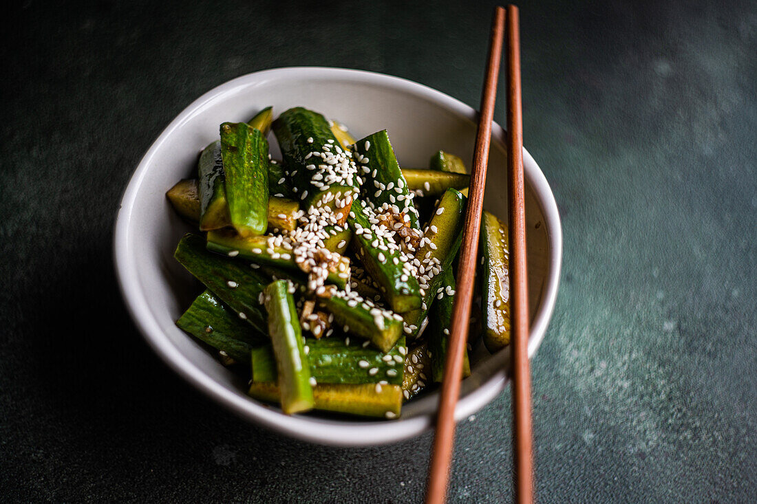 Asian spicy cucumber salad with soy sauce and sesame seeds