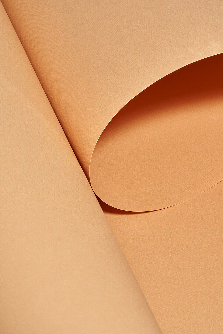 High angle of naturally rolled craft paper background with a beautiful studio light