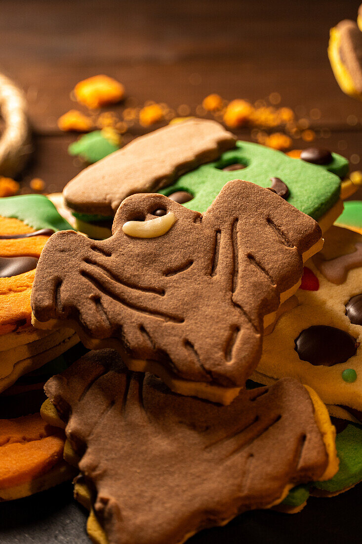 Closeup of bunch of delicious homemade biscuits placed on wooden table in Halloween style