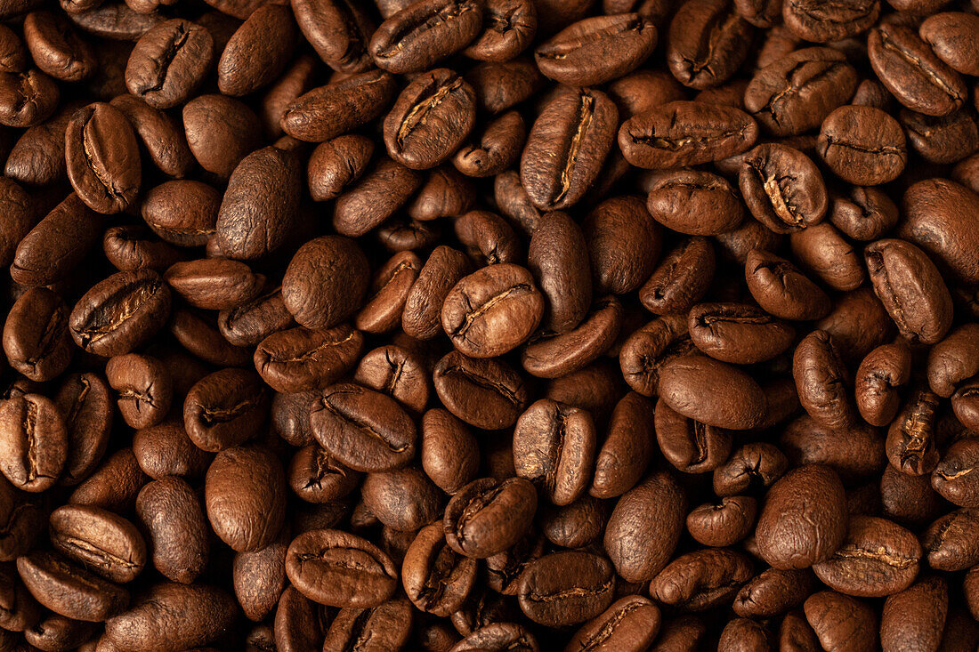 Top view of backdrop representing halves of dark brown coffee beans with pleasant scent