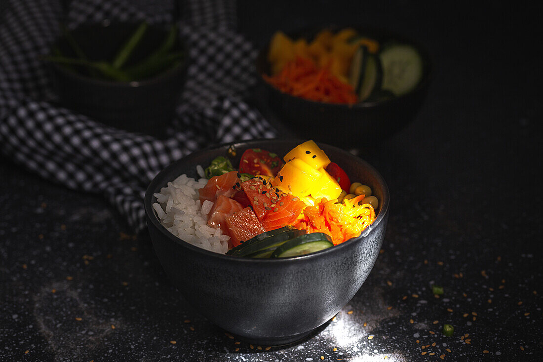 Asiatischer Poke mit Lachs und Reis mit verschiedenen Gemüsesorten, serviert in einer Schüssel auf einem Tisch in einem Restaurant
