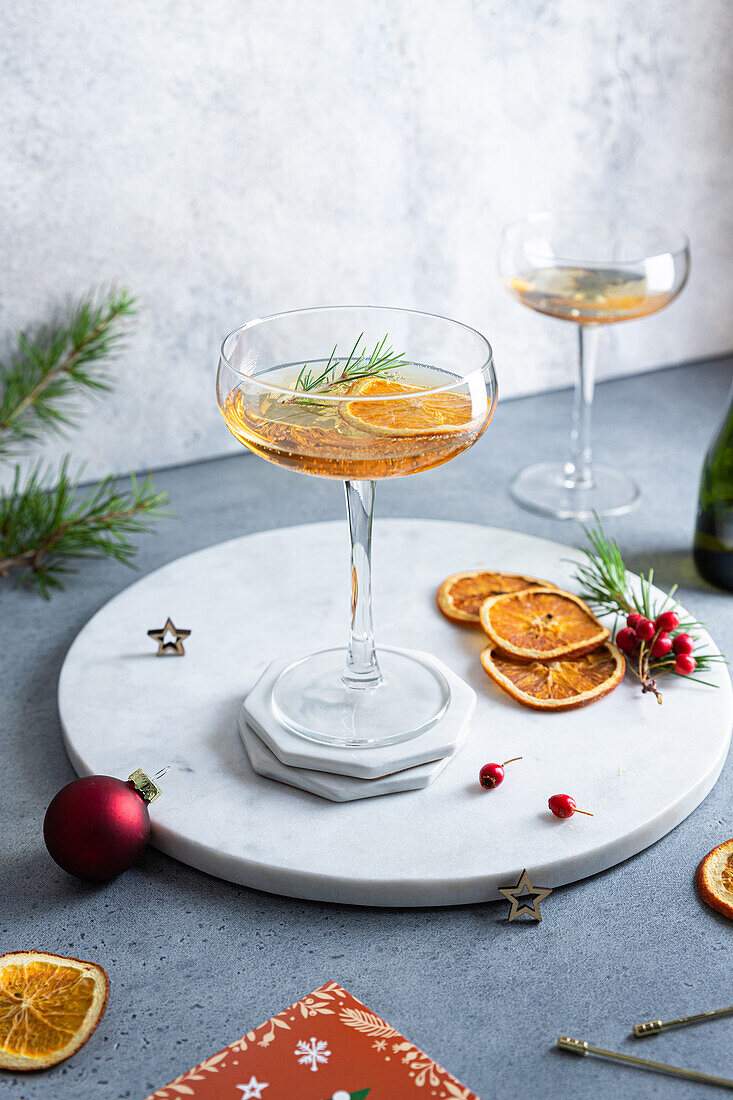 High angle of served table with orange cocktail and christmas decorations
