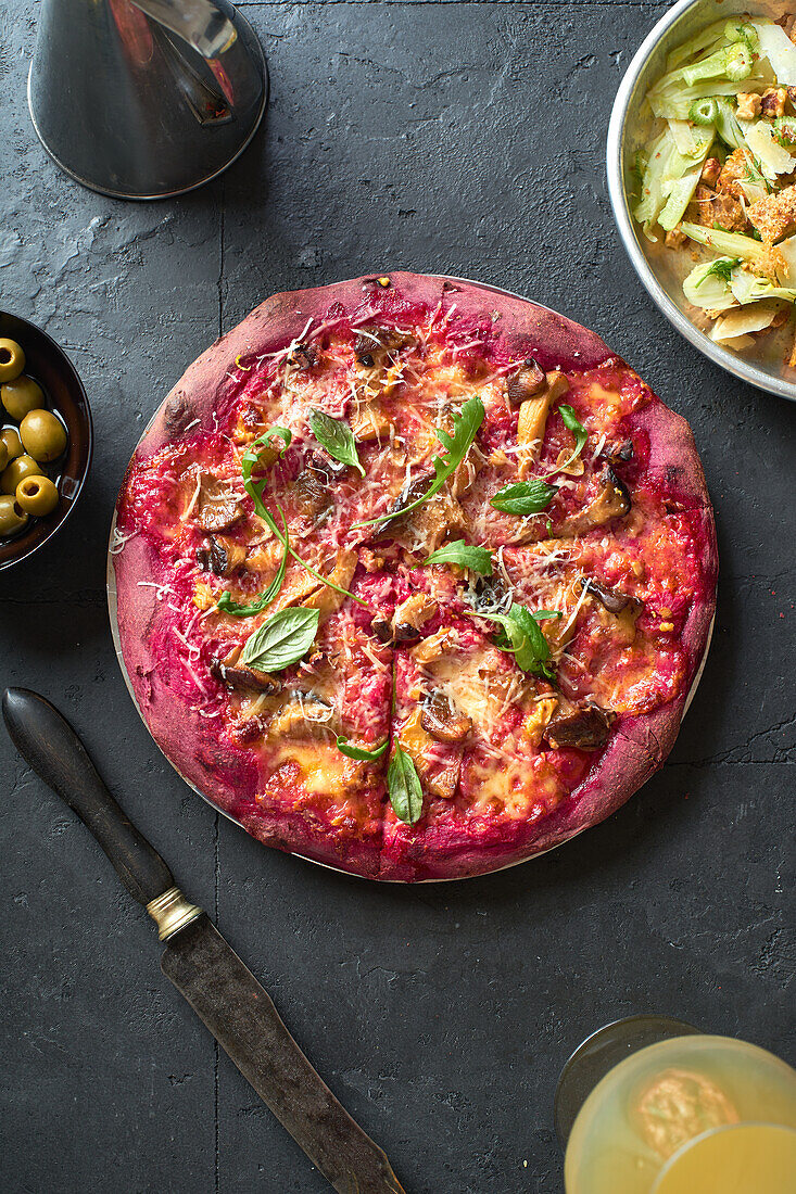 Pink colored rustic pizza with vegetables