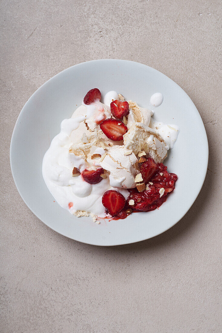 Dessert with strawberries, meringue and whipped cream viewed from above