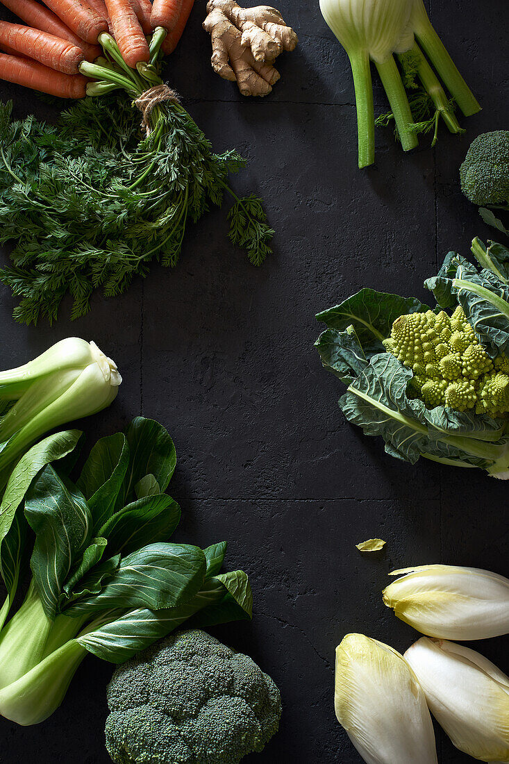 From above still life with fresh fruits and vegetables on dark background