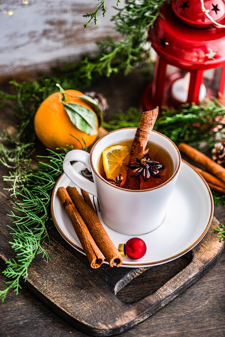 Winter hot tea with spices and lemon in the cup