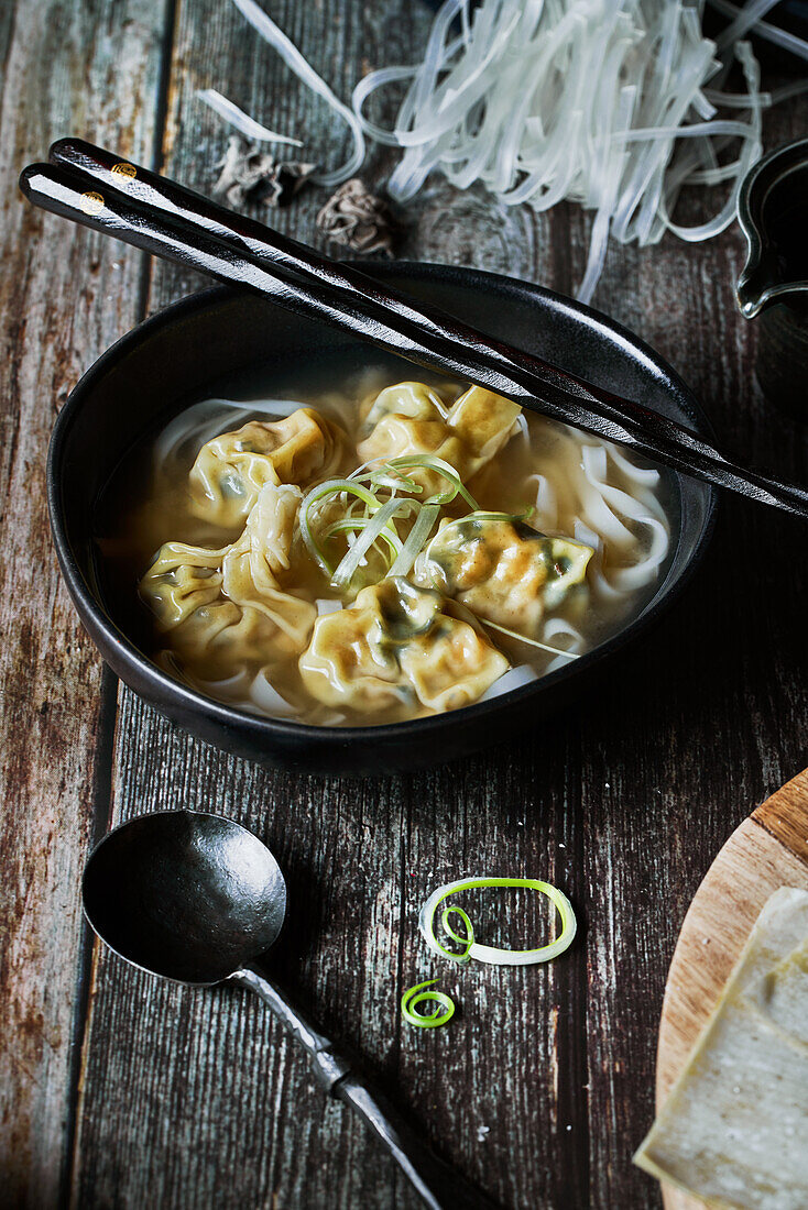 From above wonton soup on a wooden table