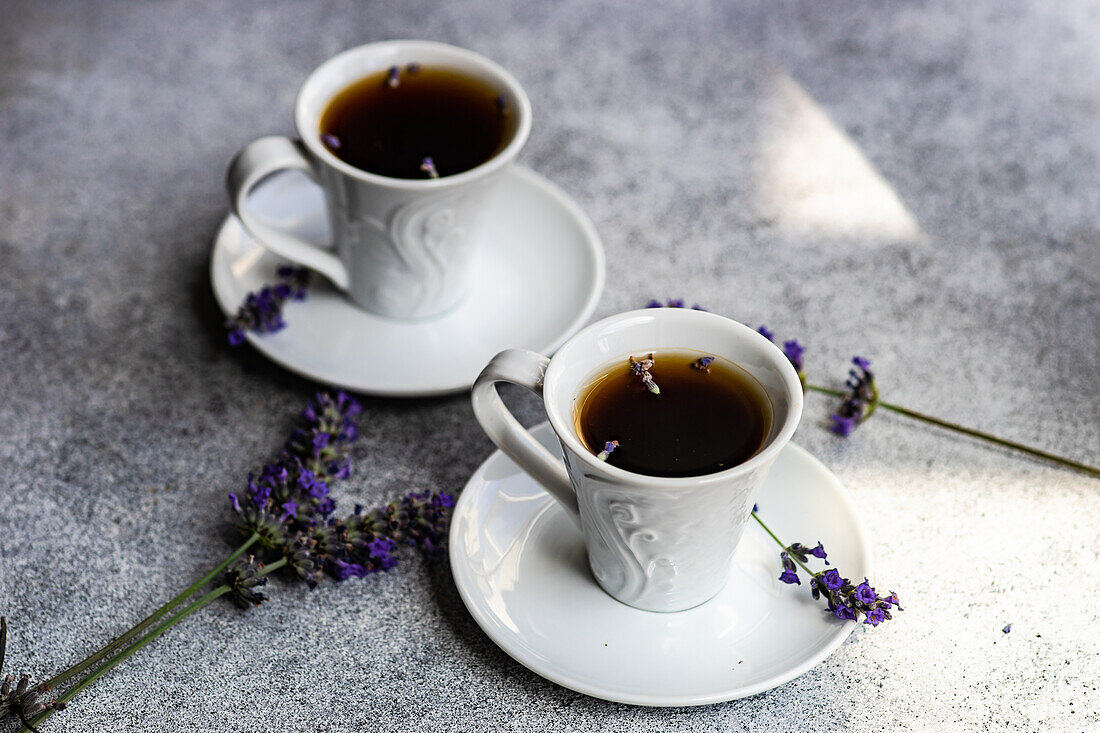 Overhead view of espresso coffees with lavender on concrete background