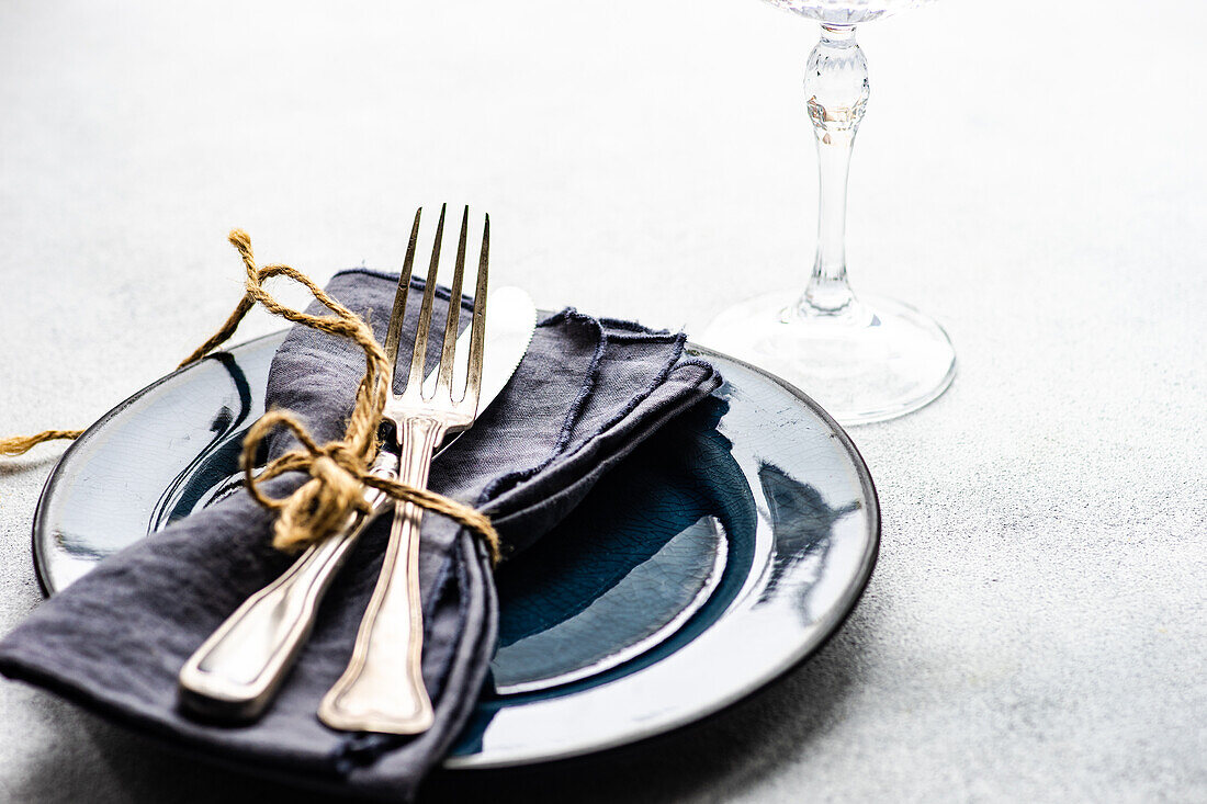 Minimalistic cutlery set on the concrete background