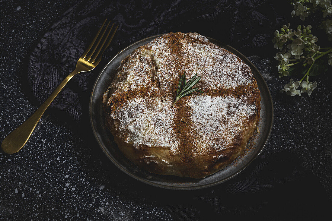 From above of appetizing bastilla with aromatic spices on table near flower sprig during Ramadan holidays