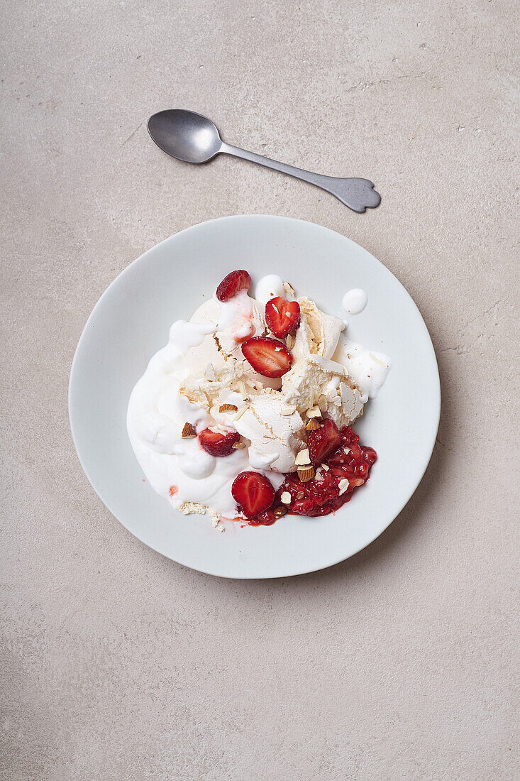 Dessert with strawberries, meringue and whipped cream viewed from above