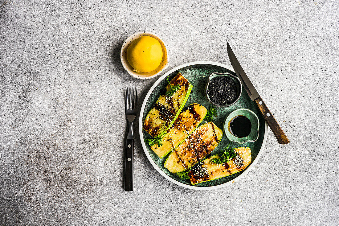 From above roasted on grill zucchini slices served on the plate