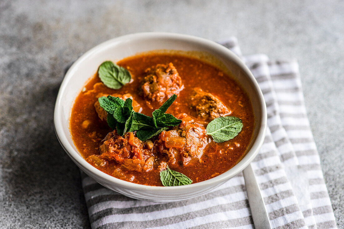 Stewed spicy meatballs in tomato sauce served in the bowl