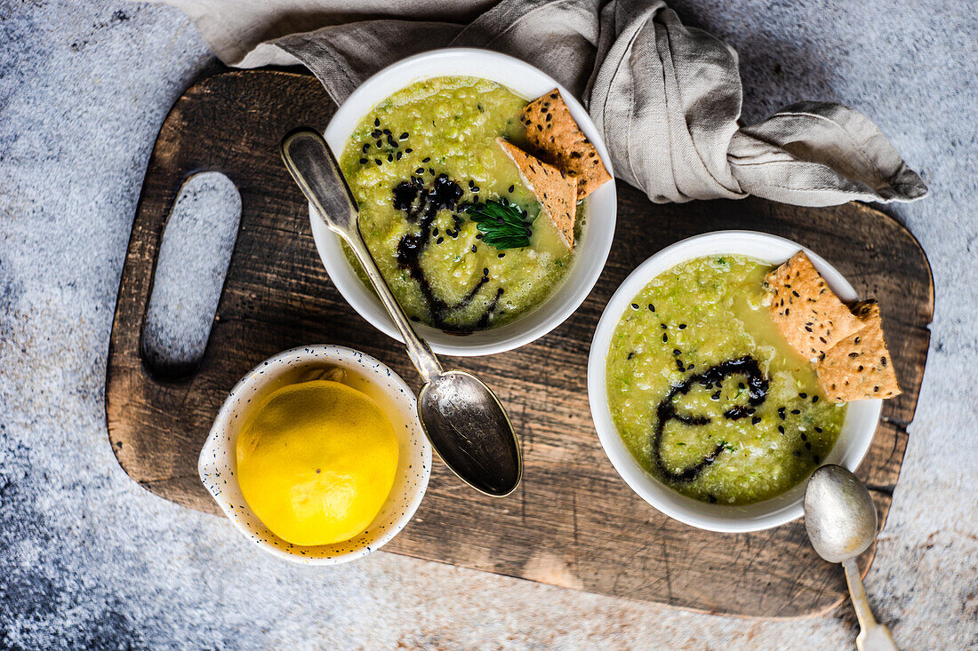 From above healthy zucchini soup in the bowl with crackers