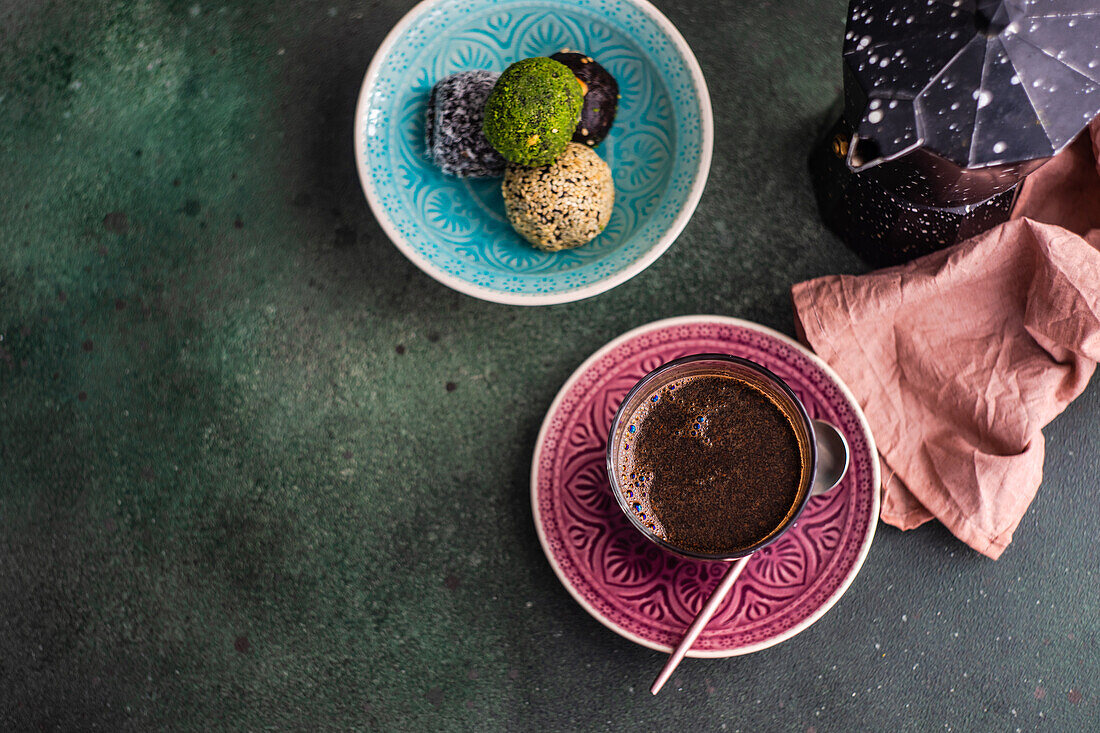 From above geyser coffee maker near glass of coffee and traditional turkish pakhlava on concrete table