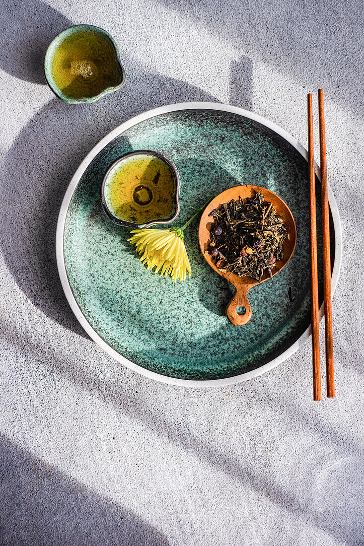 Top view of asian green tea set with yellow autumnal Chrysanth flowers served on concrete table