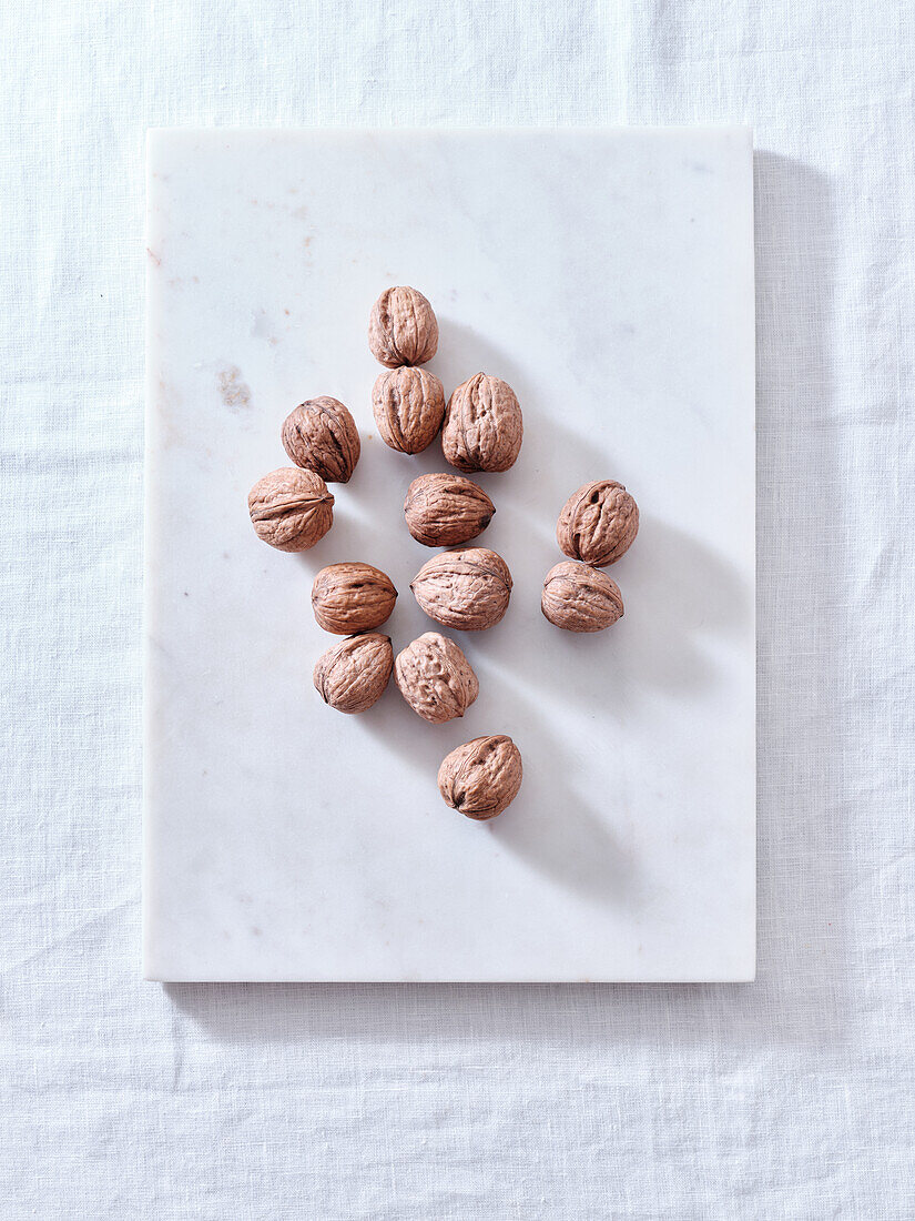 Opening walnuts with a cracker top view. White background