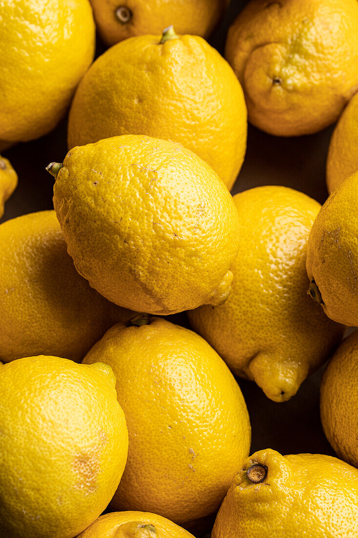 Top view full frame composition of fresh ripe lemons placed together as background