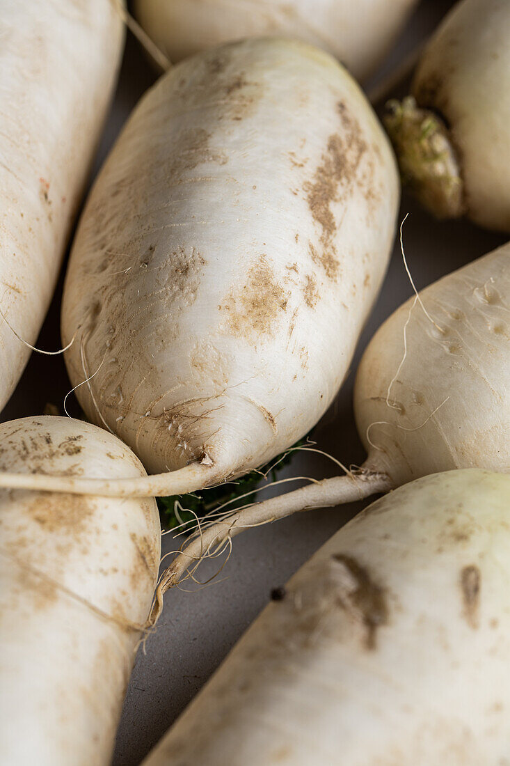 From above full frame of raw fresh radishes placed on table as background