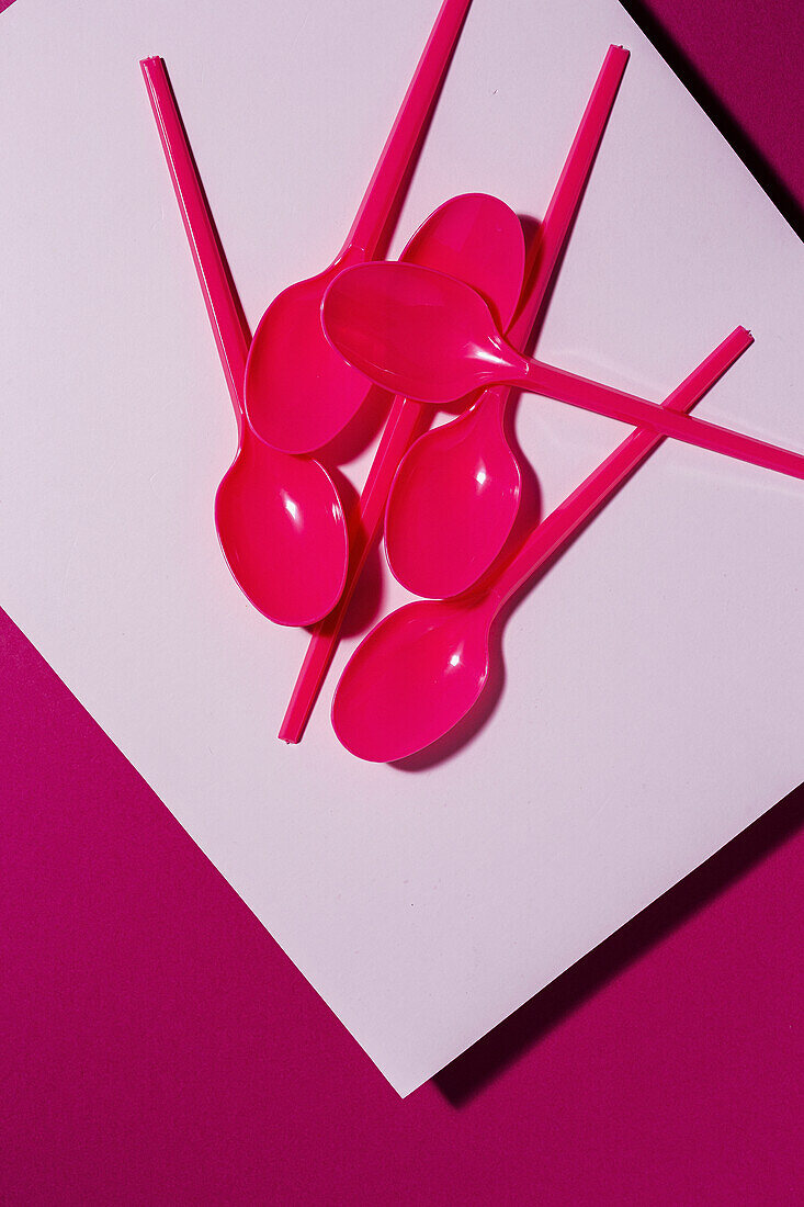 From above view of bright pink eco friendly spoon on pink carton background