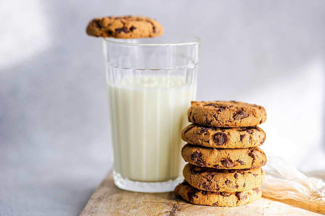 Healthy oat cookies with chocolate and glass of yogurt on the concrete or stone table