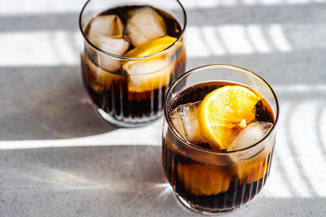 Alcohol cocktail Cuba Libre with orange slice and ice in the glass