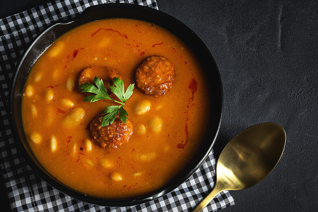 Delicious plate of beans with chorizo seen from above