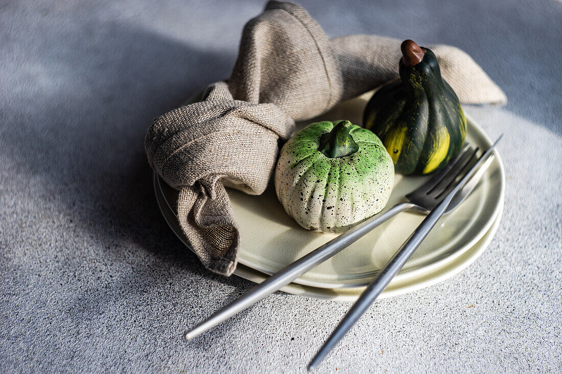 Festive place setting for autumnal dinner with holiday seasonal decoration
