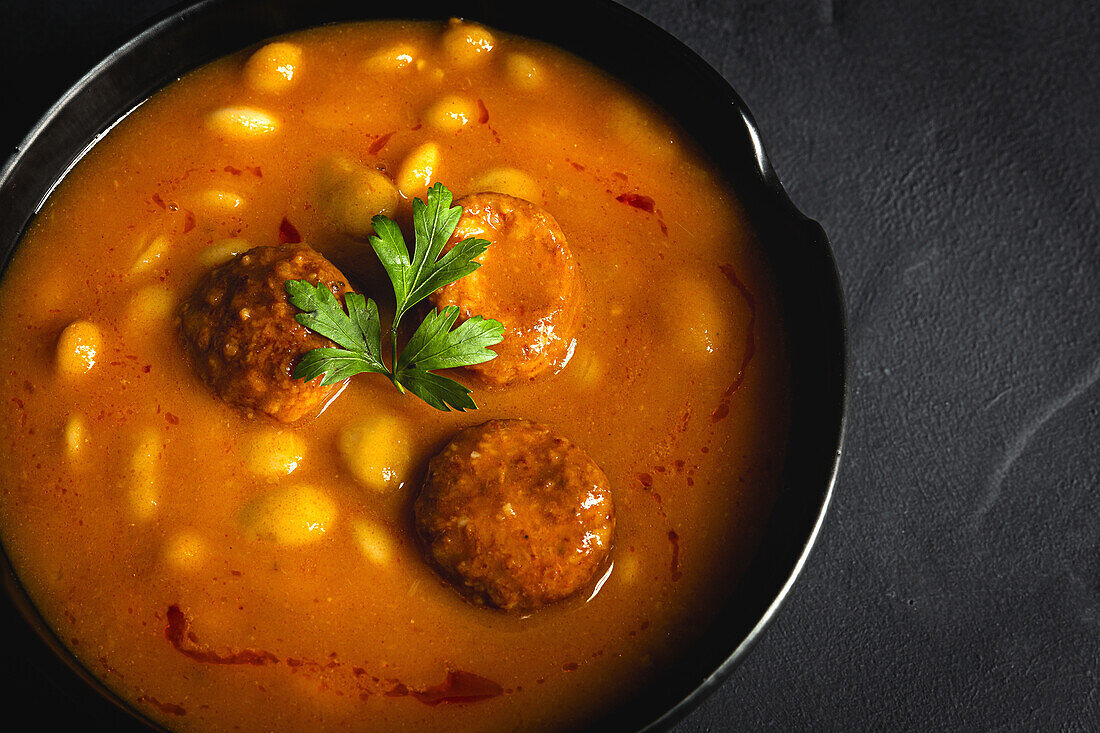 Delicious plate of beans with chorizo seen from above